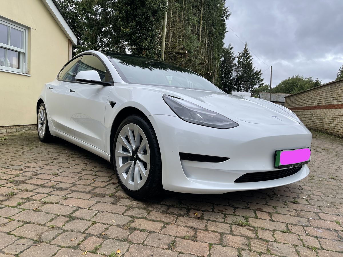 A photo of my new Tesla Model 3 in white with sports wheels A photo of my new Tesla Model 3 in white with sports wheels